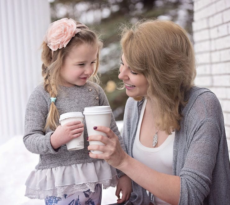 Mother and Daughter Holding Takeout Cups Mother and Daughter Holding Takeout Cups
